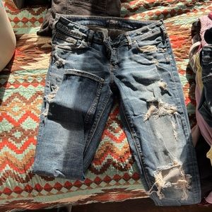 Distressed silver jeans